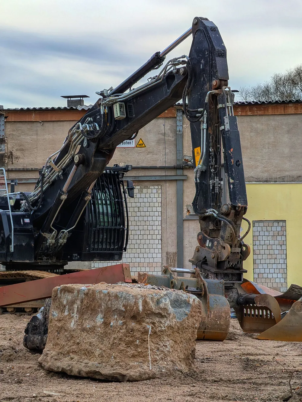 Excavator working on a cleared construction site